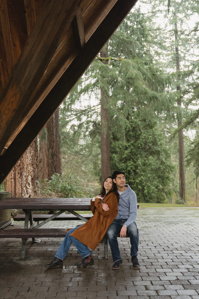 couple posing for engagement photos at hoyt arboretum
