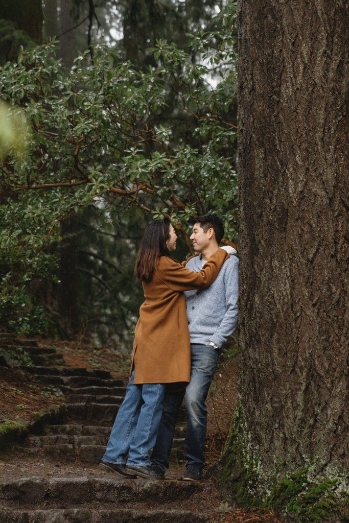 couple posing for engagement photos at hoyt arboretum

