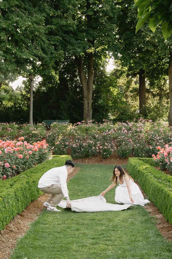 Candid moment of a couple laughing together in a peaceful garden.
