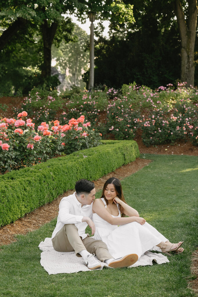 Candid moment of a couple laughing together in a peaceful garden.
