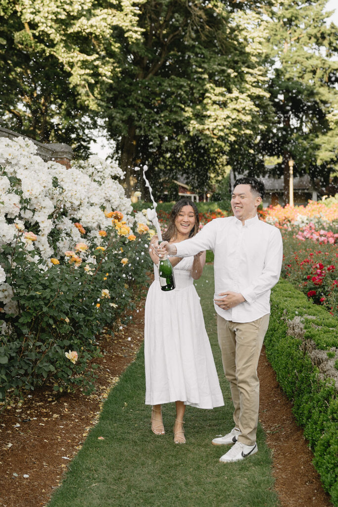 Candid moment of a couple laughing together in a peaceful garden.
