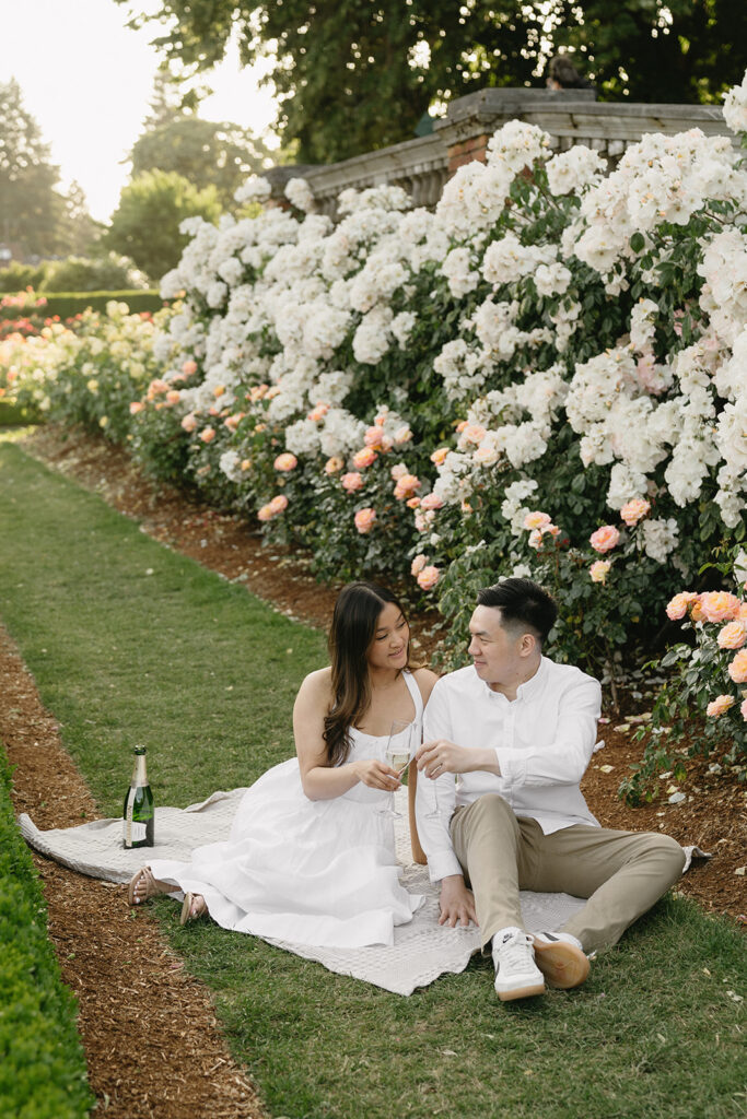Candid moment of a couple laughing together in a peaceful garden.
