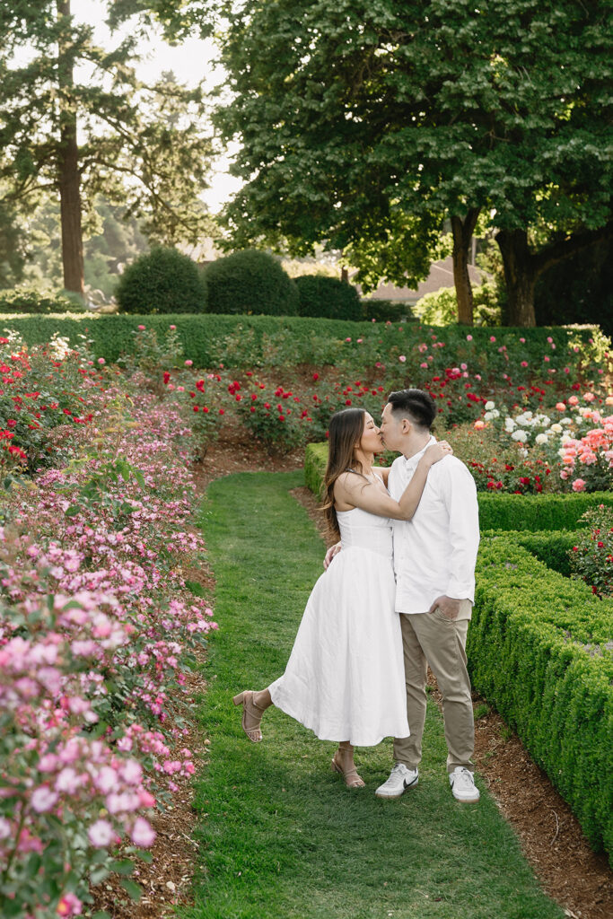 Candid moment of a couple laughing together in a peaceful garden.
