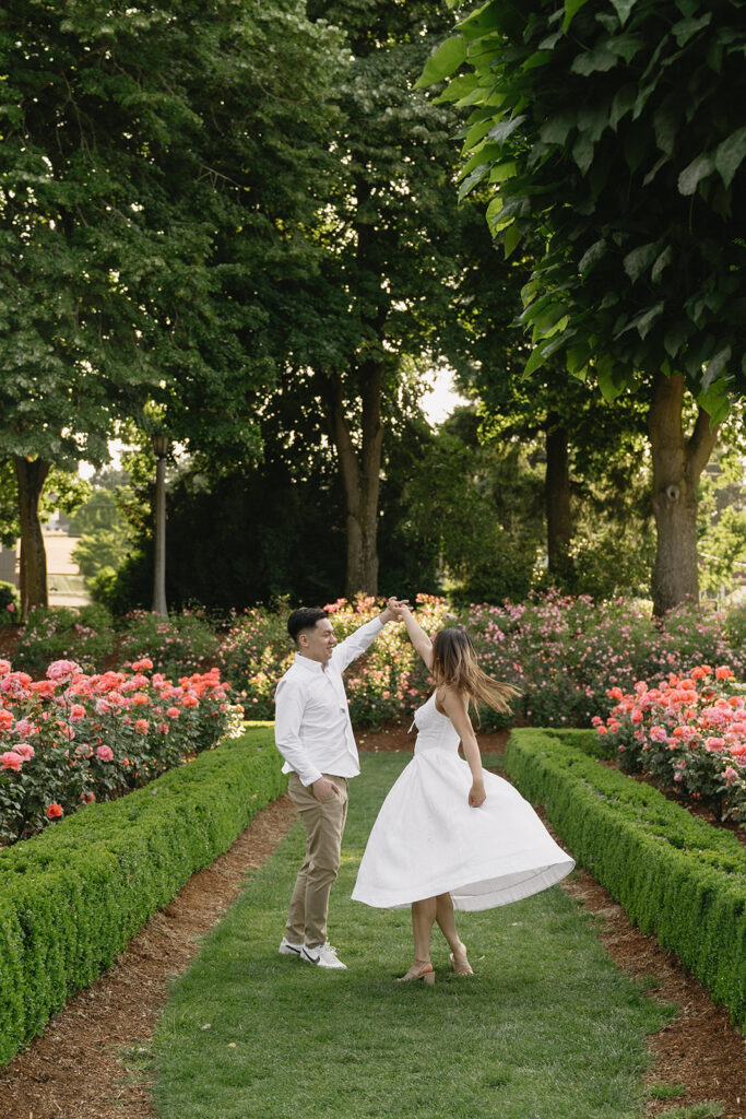 Candid moment of a couple laughing together in a peaceful garden.
