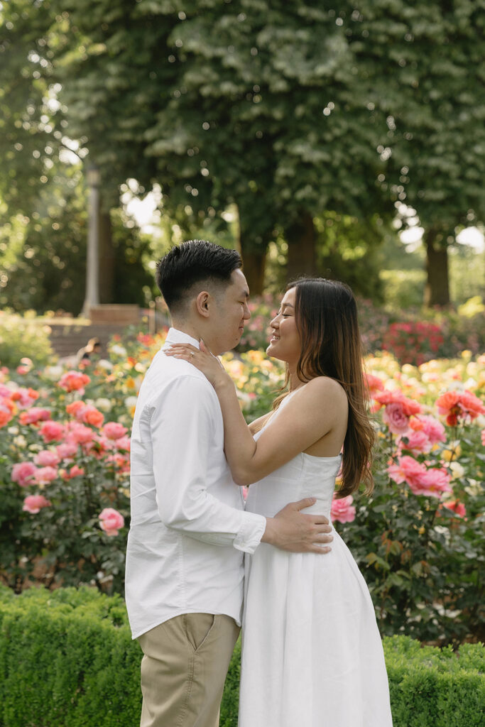 Candid moment of a couple laughing together in a peaceful garden.
