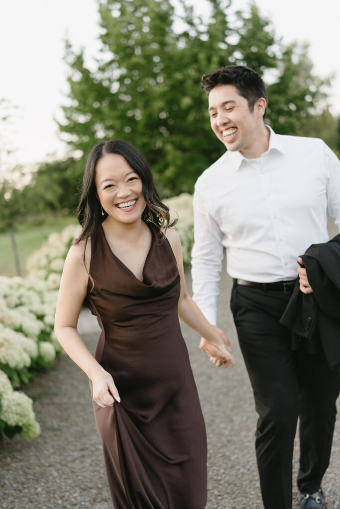 Romantic engagement photo surrounded by blooming hydrangeas at a vineyard estate
