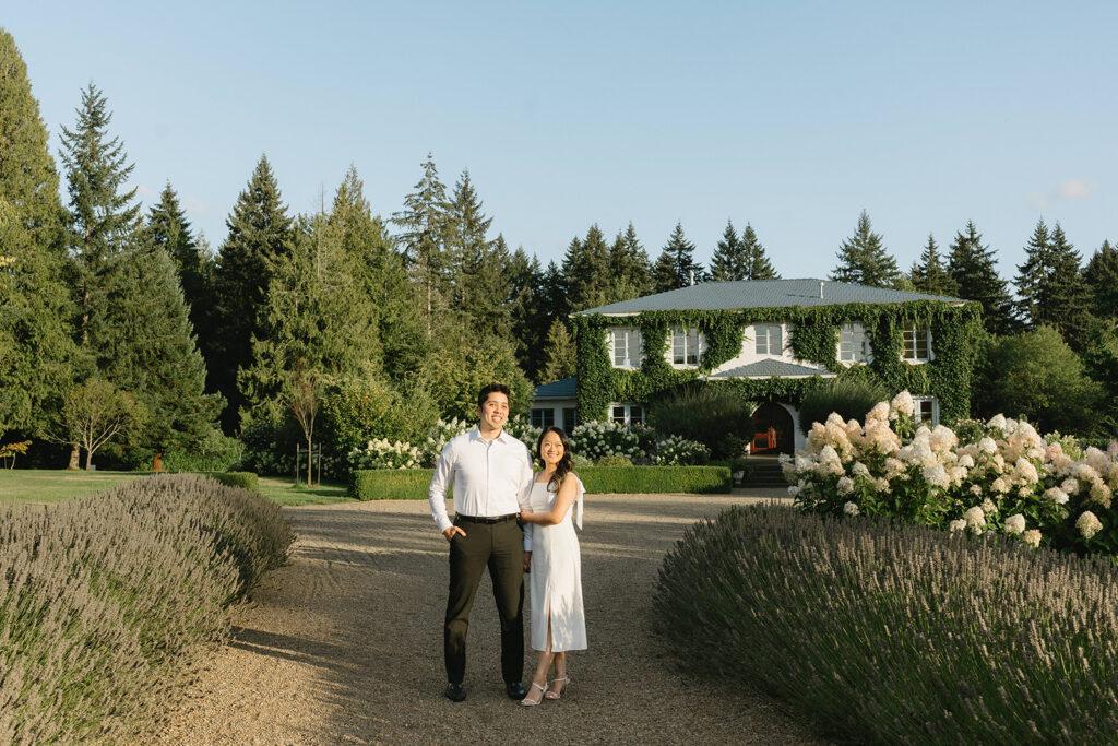 Couple exploring vineyard paths and stone archways during engagement shoot
