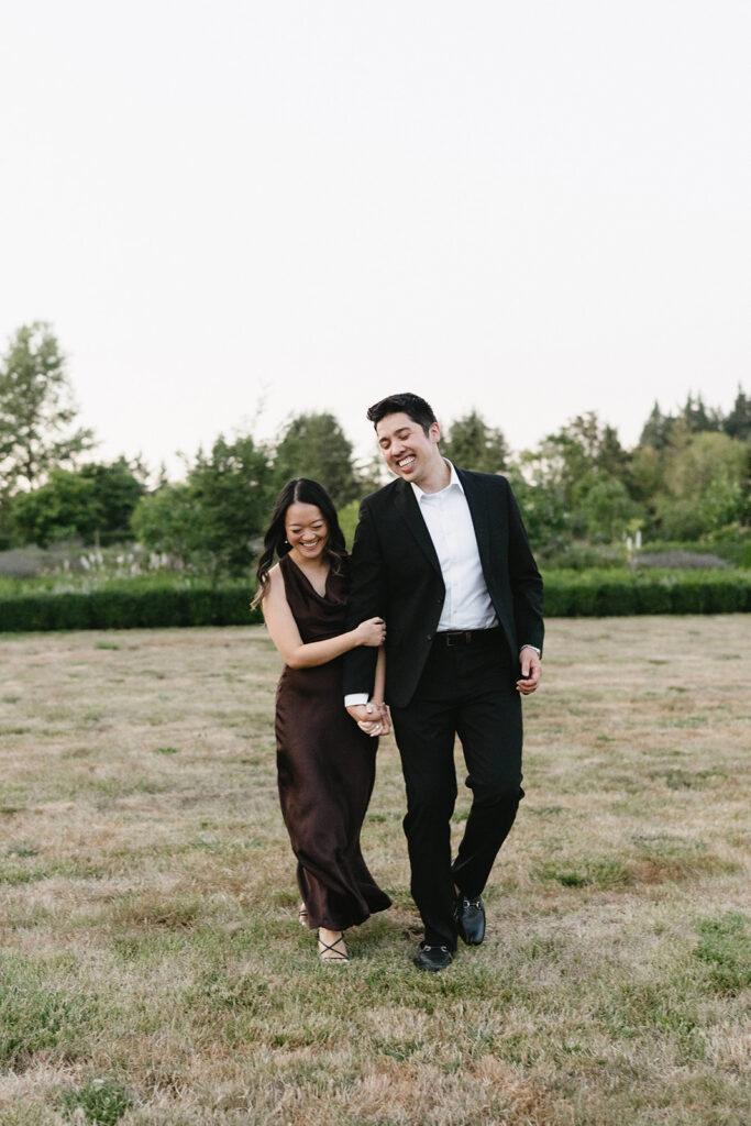 Couple walking through the gardens at during their engagement session
