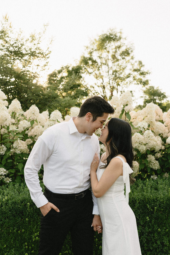 Couple walking through the gardens at during their engagement session
