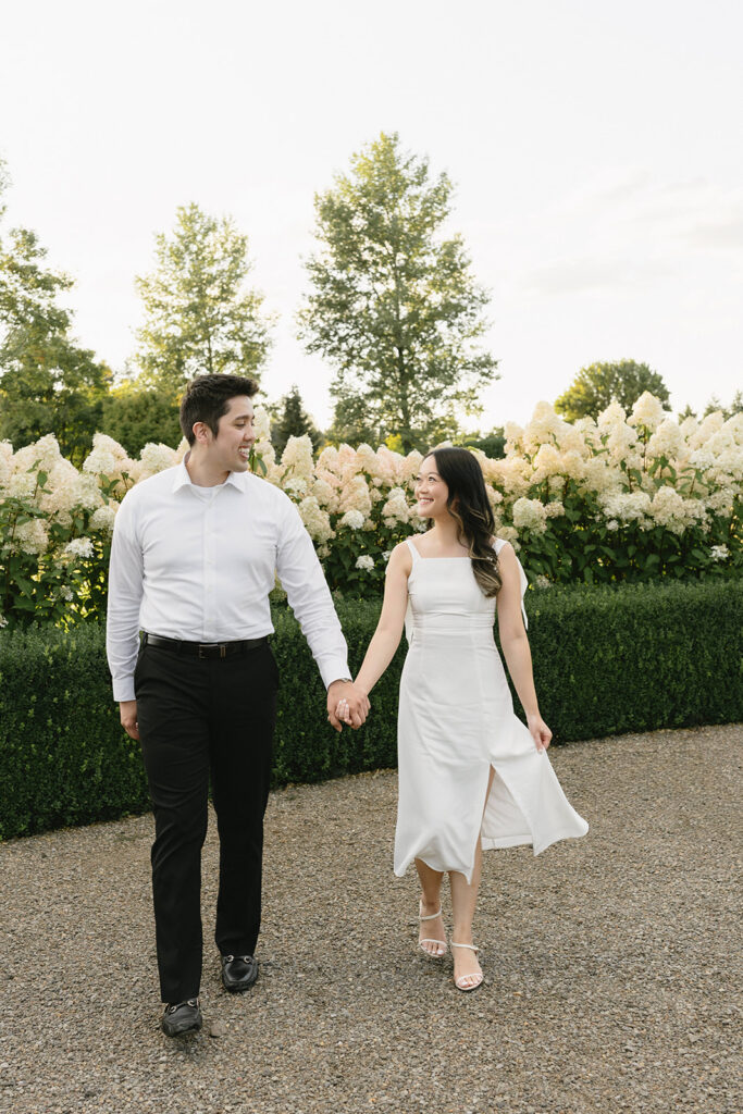 Natural candid engagement photo in a romantic garden setting
