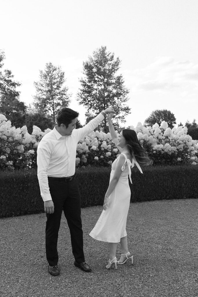 Natural candid engagement photo in a romantic garden setting
