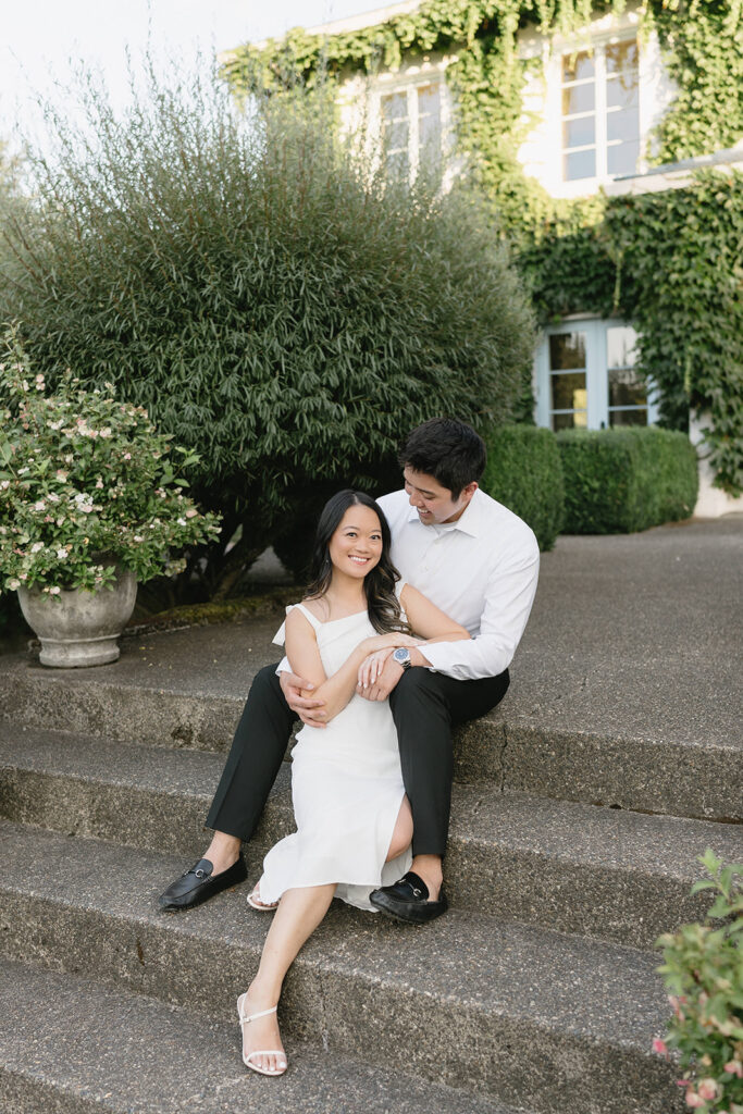 Couple walking through the gardens at Monet Vineyard during their engagement session
