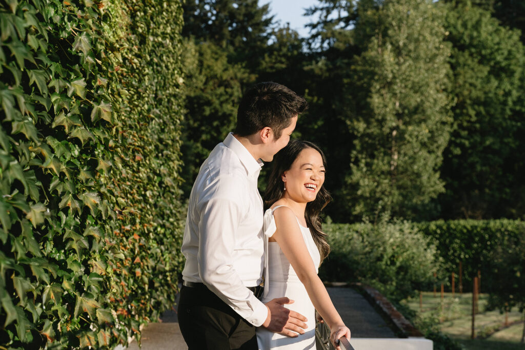 Couple exploring vineyard paths and stone archways during engagement shoot
