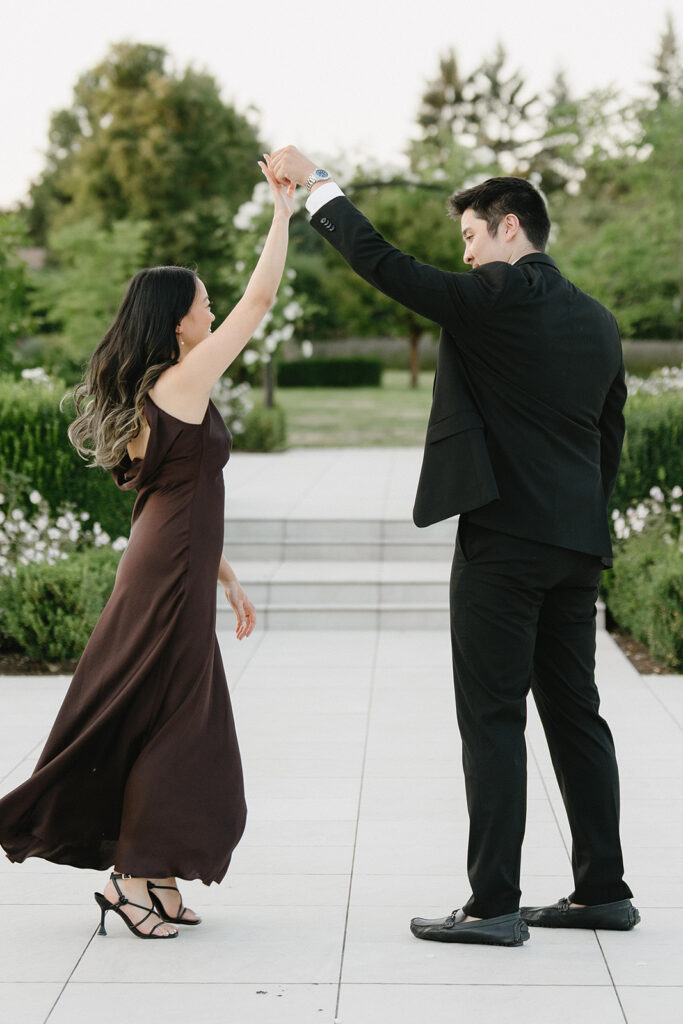 Romantic engagement photo surrounded by blooming hydrangeas at a vineyard estate
