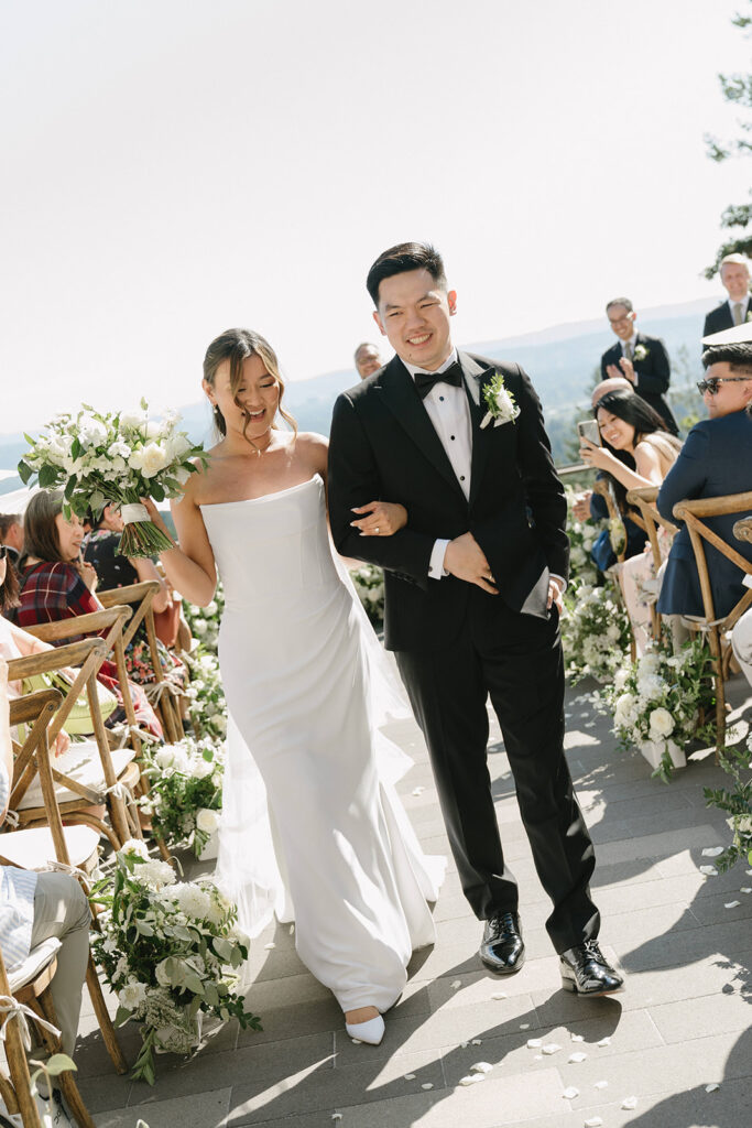 Couple walking through vineyard rows during golden hour portraits at Amaterra.
