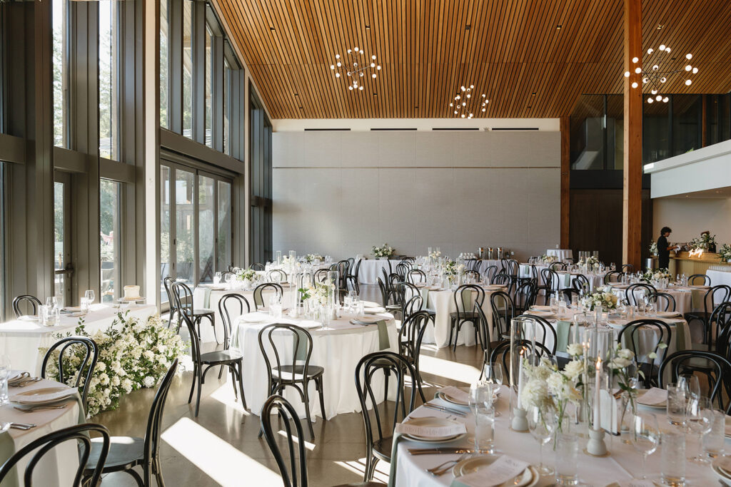 Timeless wedding reception design with neutral decor and glowing candlelight.
