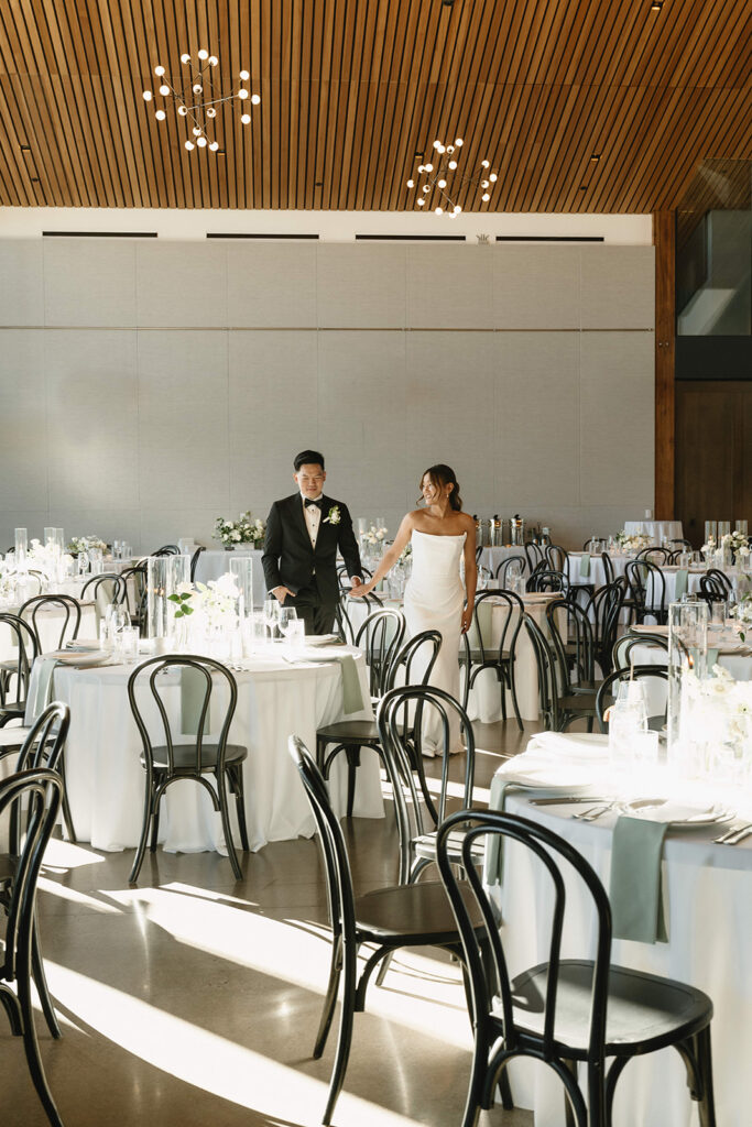 Timeless wedding reception design with neutral decor and glowing candlelight.
