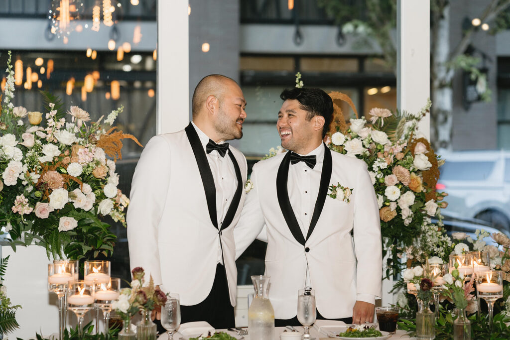 Joyful LGBT wedding celebration with guests dancing at an urban Portland venue

