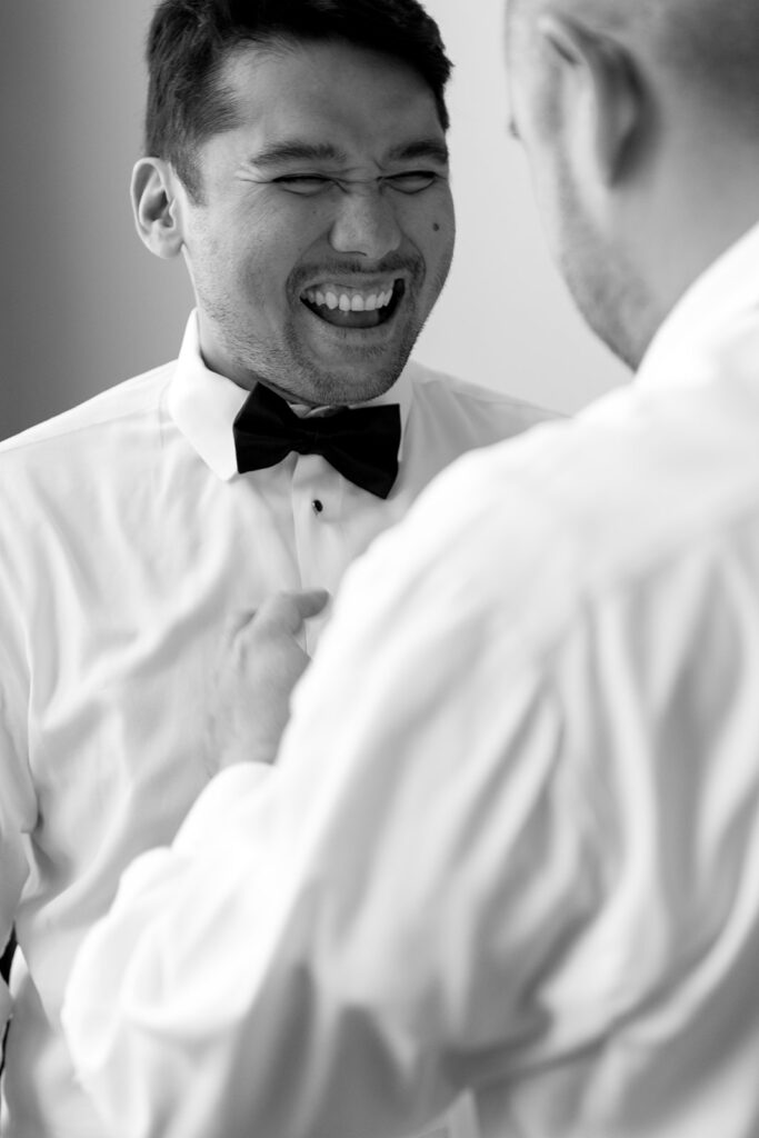 Couple getting ready together with their dog at a Portland hotel on their wedding morning
