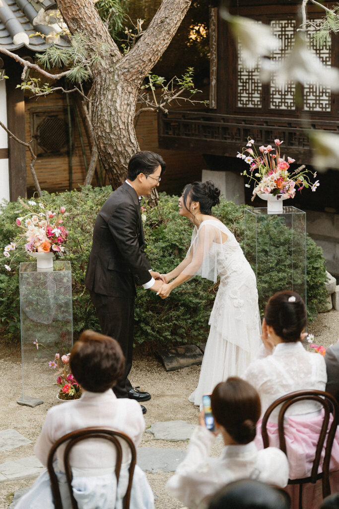 Candid guest reactions during a wedding in Seoul as friends celebrate together in an intimate destination setting.
