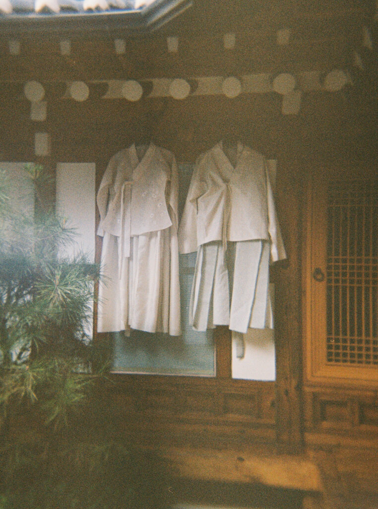 Intimate wedding in Seoul at Rakkojae Hanok with a small group of guests gathered in a traditional Korean courtyard.
