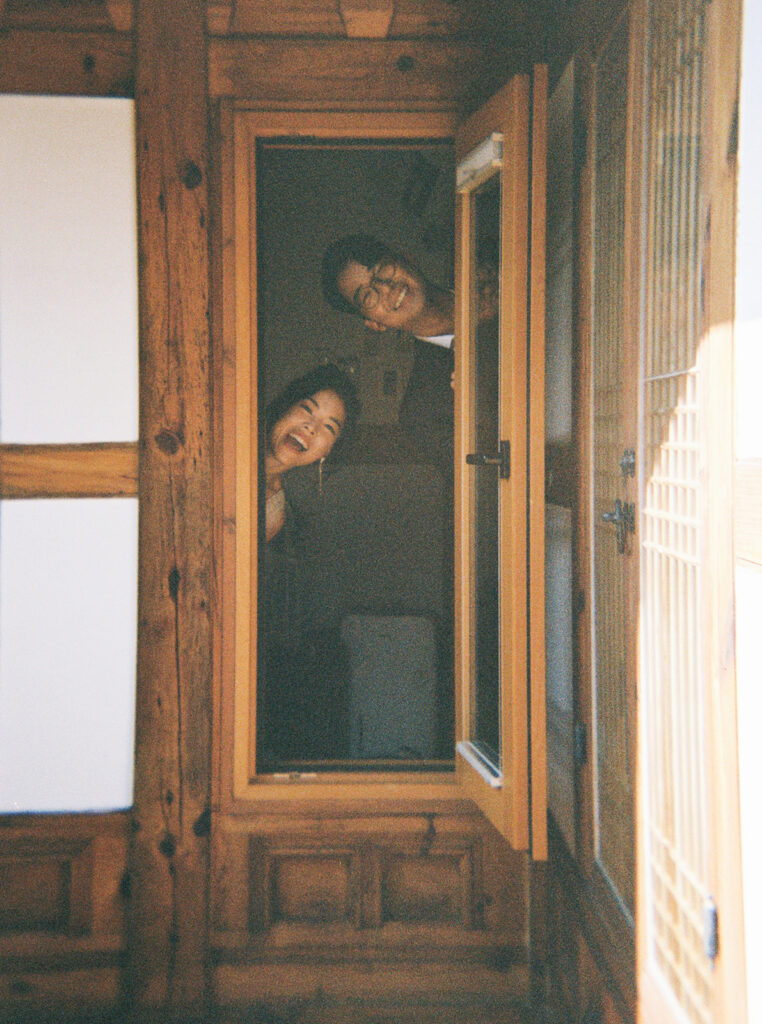 Bride and groom sharing a quiet moment during their wedding in Seoul surrounded by historic hanok architecture.
