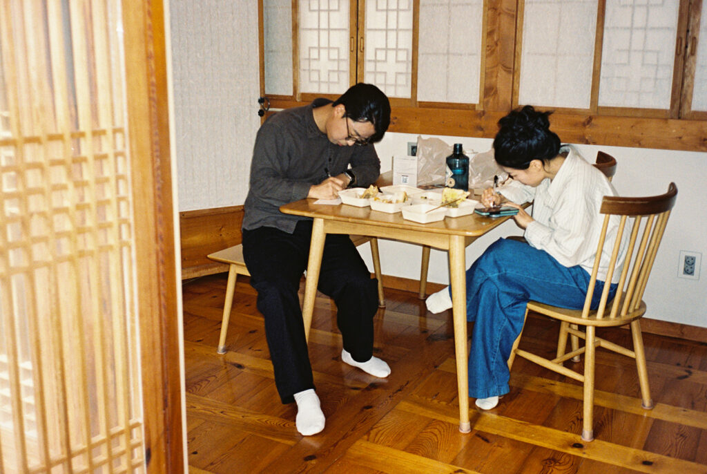 Intimate wedding in Seoul at Rakkojae Hanok with a small group of guests gathered in a traditional Korean courtyard.
