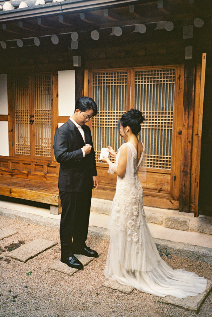 Intimate wedding in Seoul at Rakkojae Hanok with a small group of guests gathered in a traditional Korean courtyard.
