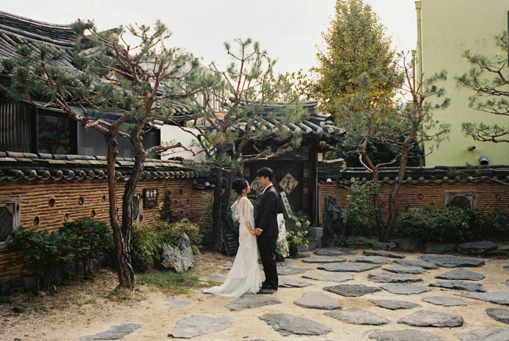 Intimate wedding in Seoul at Rakkojae Hanok with a small group of guests gathered in a traditional Korean courtyard.
