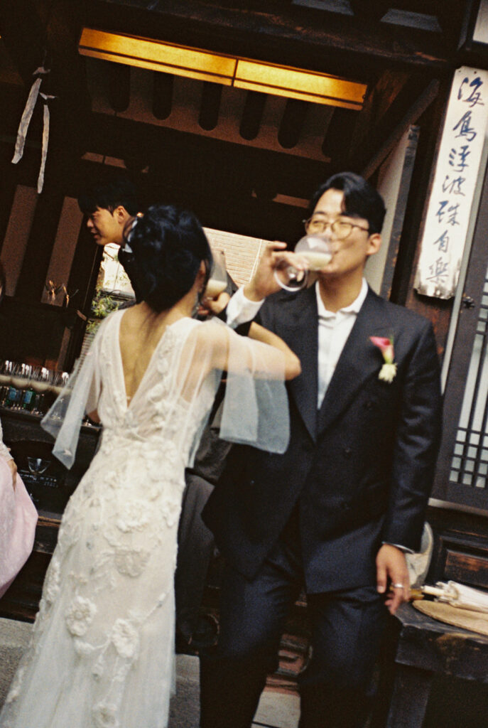 Intimate wedding in Seoul at Rakkojae Hanok with a small group of guests gathered in a traditional Korean courtyard.
