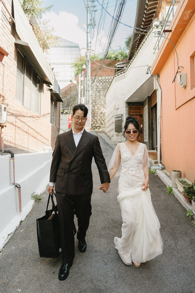 Bride and groom sharing a quiet moment during their wedding in Seoul surrounded by historic hanok architecture.
