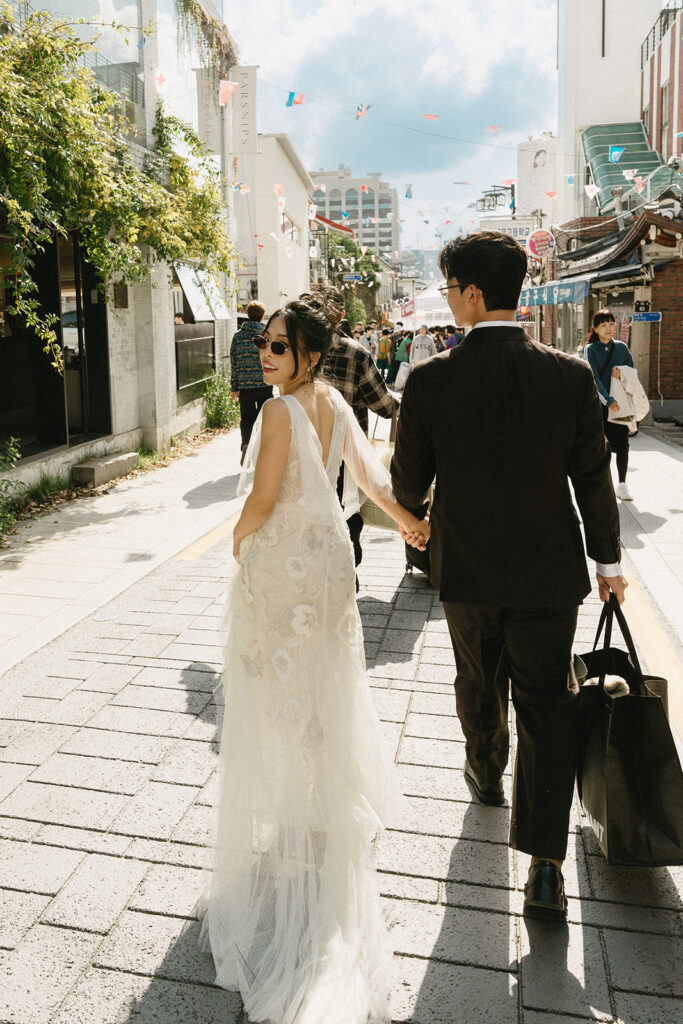 Intimate wedding in Seoul at Rakkojae Hanok with a small group of guests gathered in a traditional Korean courtyard.
