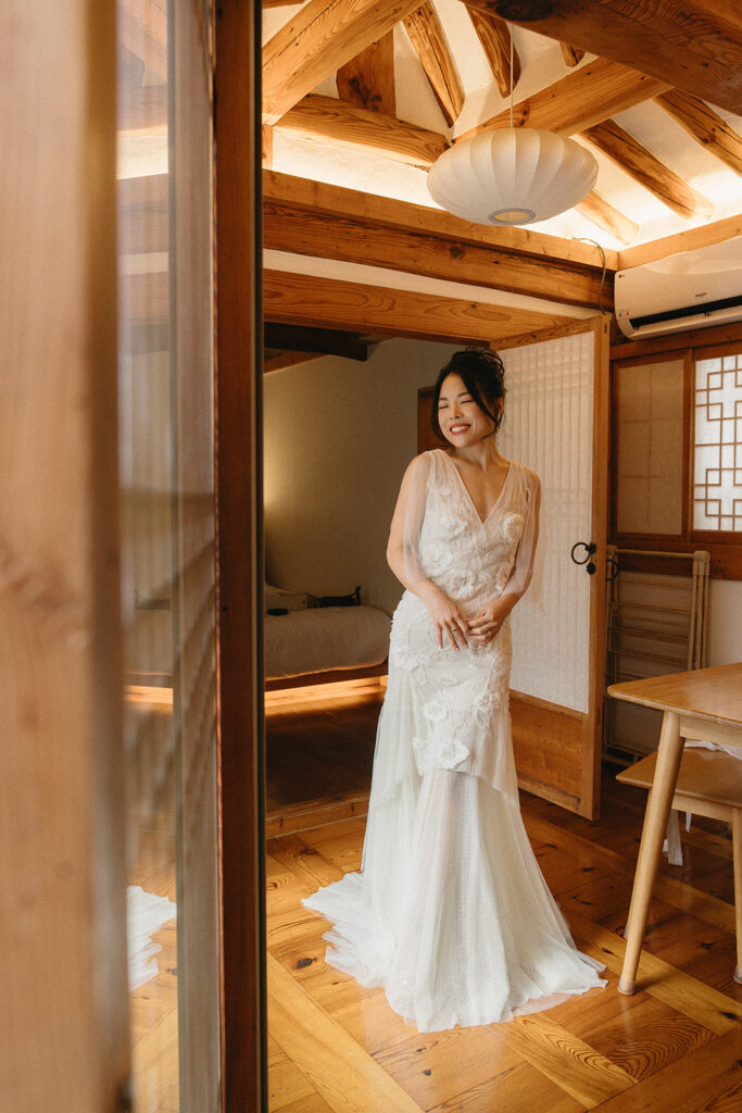 Bride and groom sharing a quiet moment during their wedding in Seoul surrounded by historic hanok architecture.
