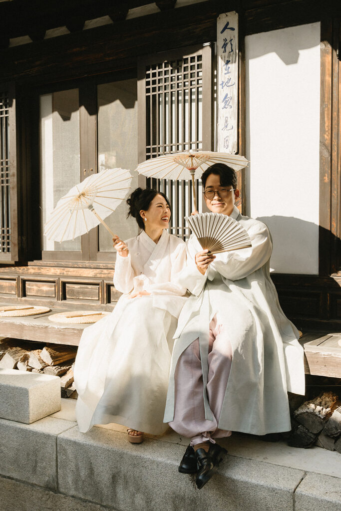 Bride and groom sharing a quiet moment during their wedding in Seoul surrounded by historic hanok architecture.

