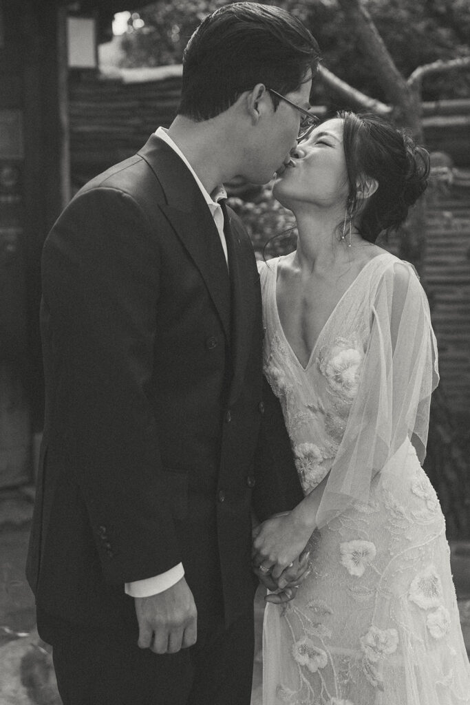 Bride and groom sharing a quiet moment during their wedding in Seoul surrounded by historic hanok architecture.
