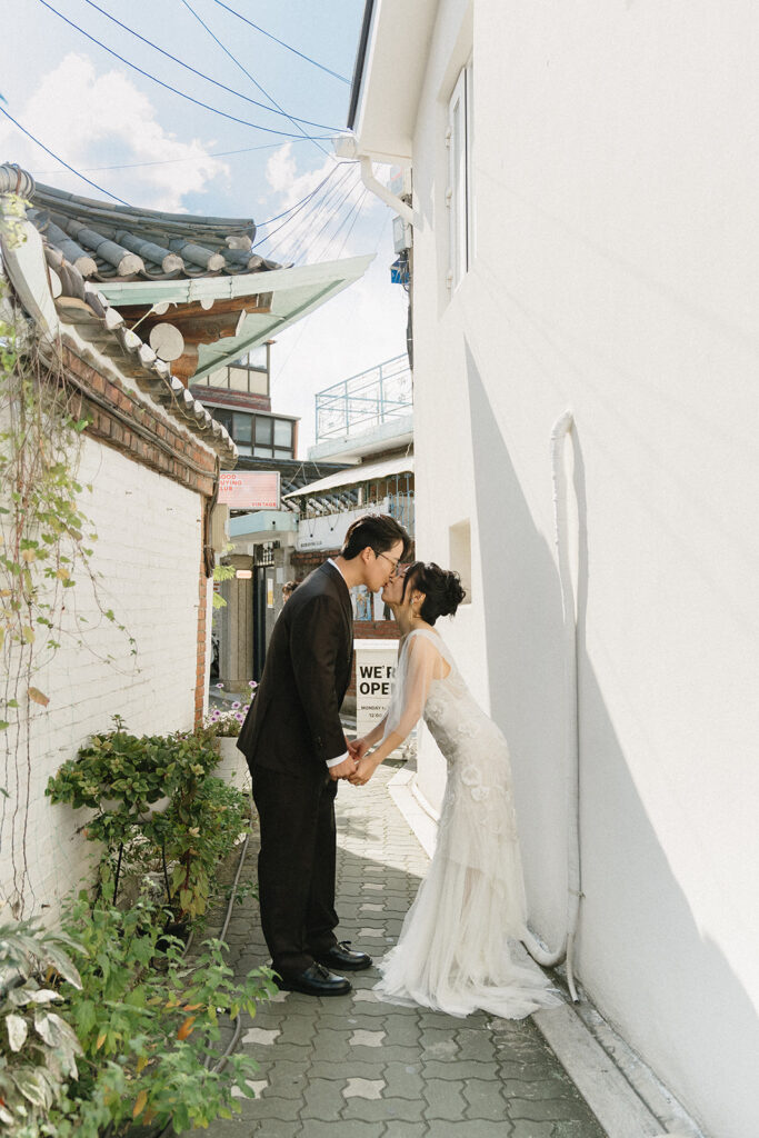 Bride and groom sharing a quiet moment during their wedding in Seoul surrounded by historic hanok architecture.
