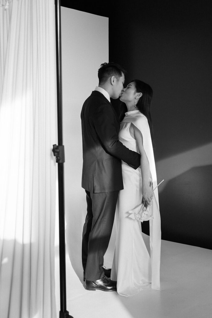 Couple standing in an arched doorway at Cream Creative Space in Portland Oregon during timeless and elegant pre-wedding portraits in studio in Portland with classic wedding styling.
