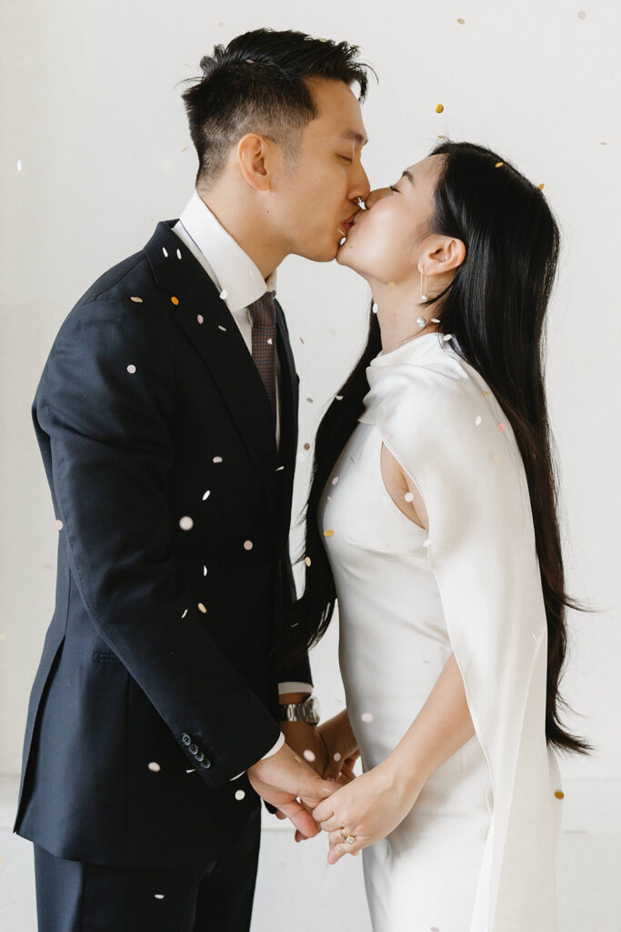 Couple standing in an arched doorway at Cream Creative Space in Portland Oregon during timeless and elegant pre-wedding portraits in studio in Portland with classic wedding styling.
