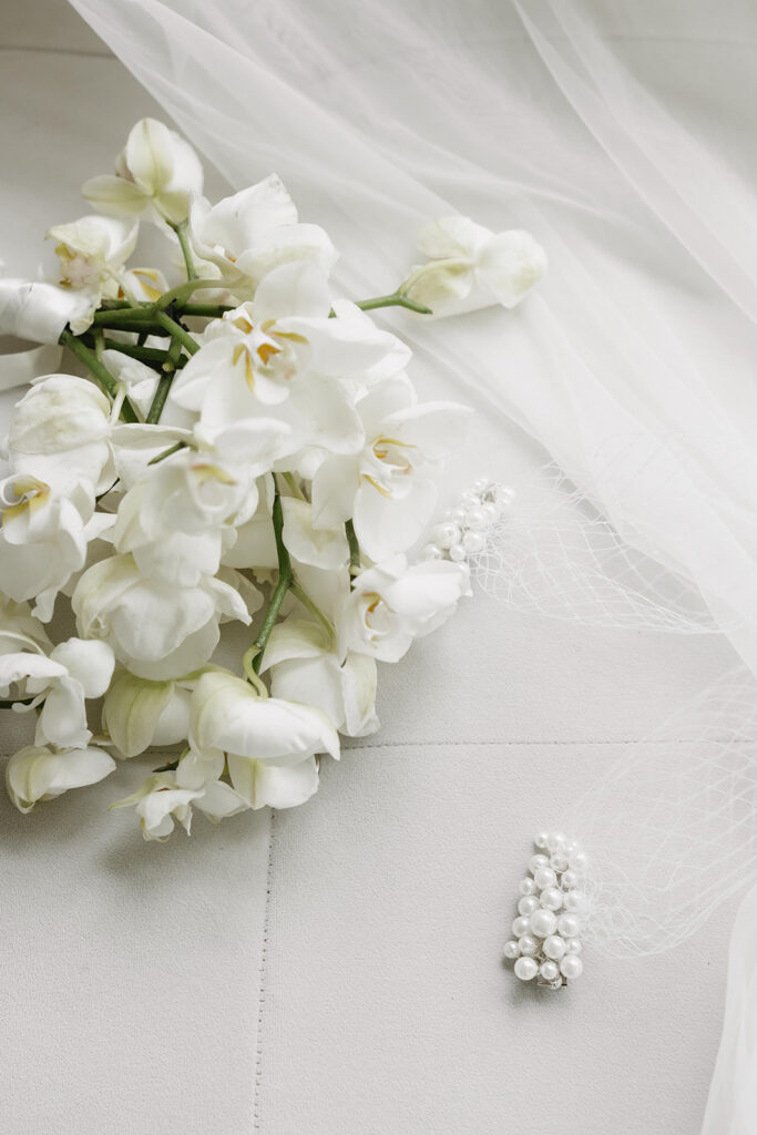 Couple embracing in a modern studio space with clean architectural details and simple styling.
