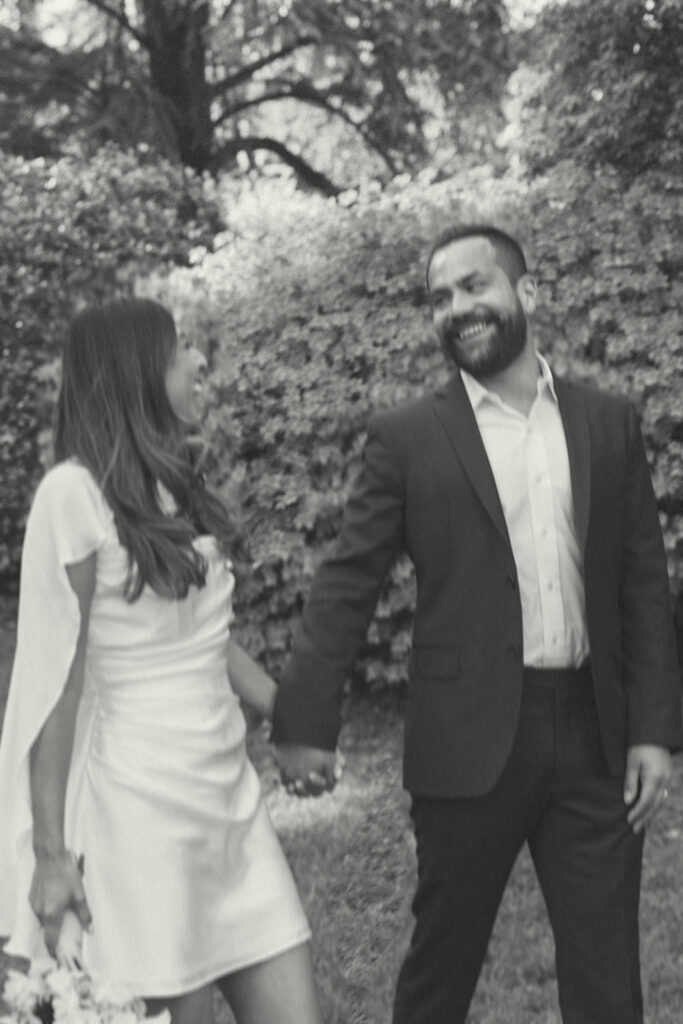 Civil union wedding portraits at the International Rose Garden in Portland, Oregon with couple walking together at sunset
